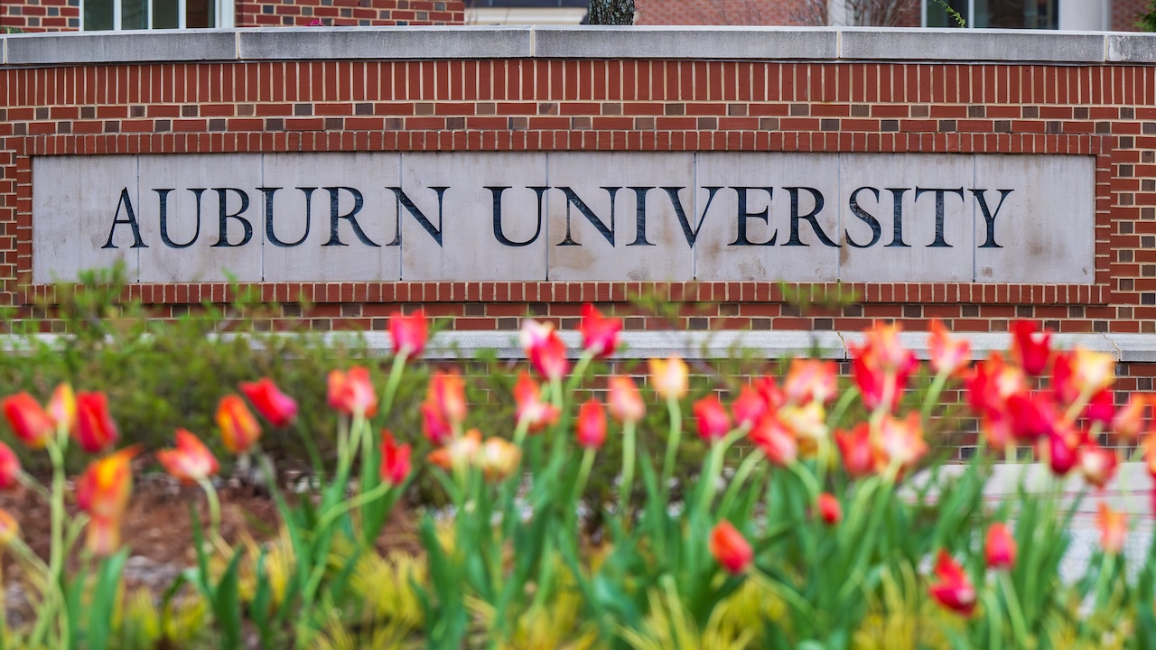 auburn university sign with flowers in front