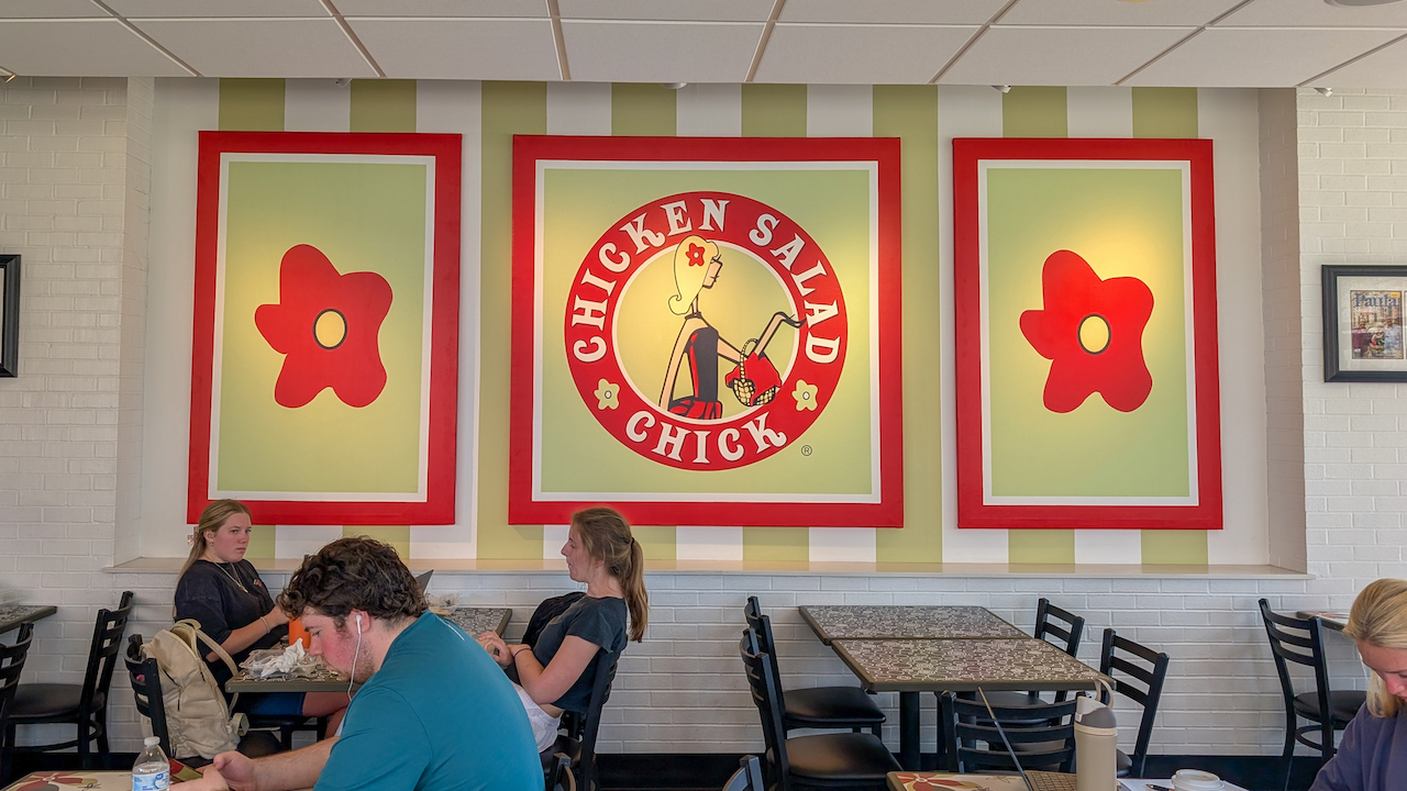 chicken salad chick logo on the wall inside the foy commons location