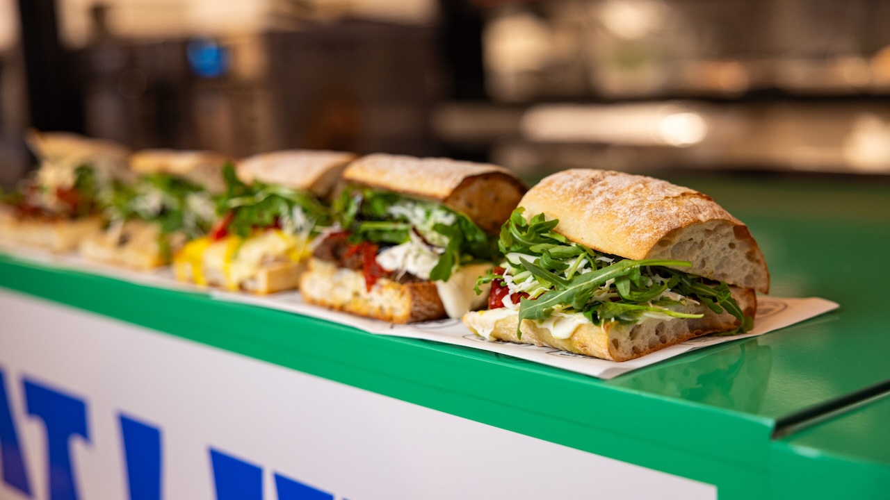 italian sandwiches lined up on a counter