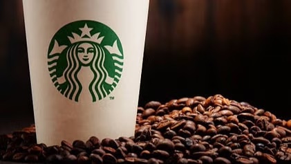 starbucks cup sitting in coffee beans