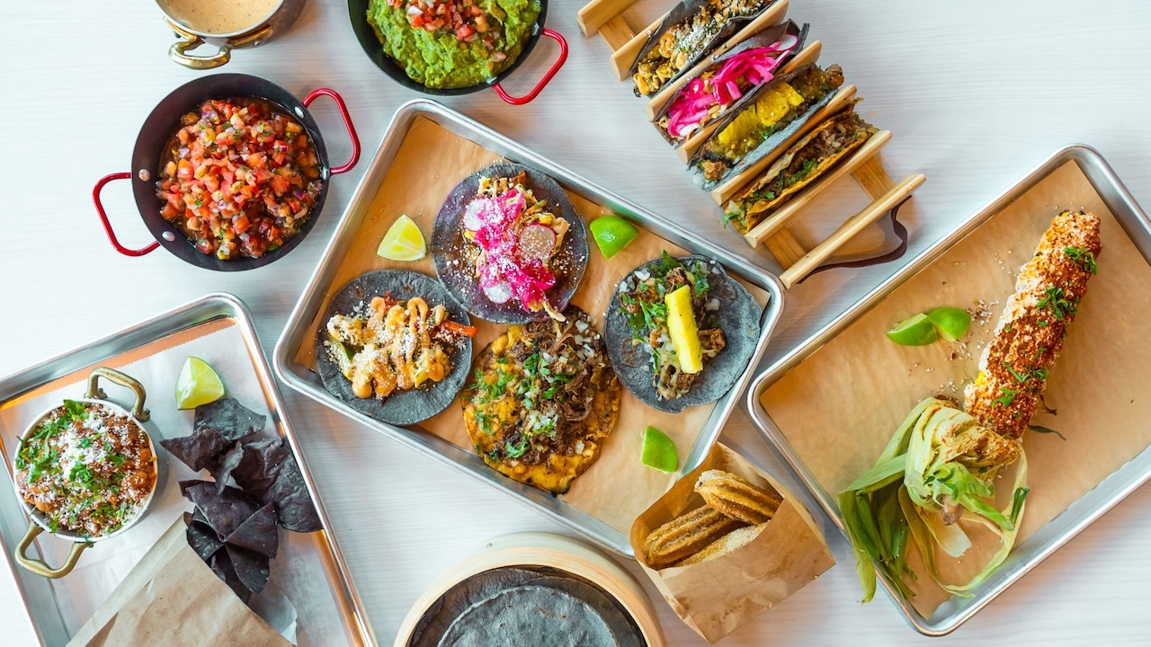 a spread of various tacos and sides