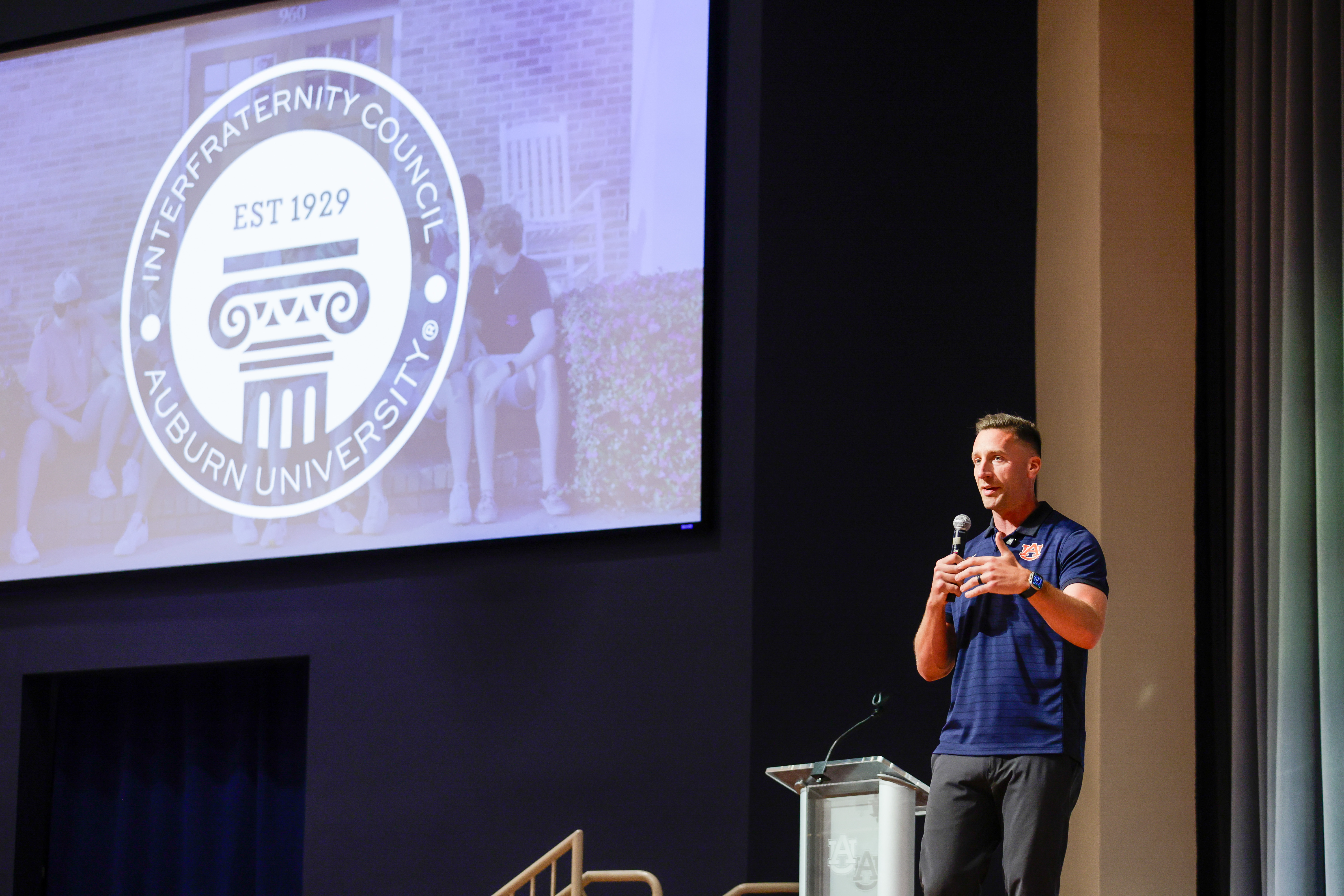 Man speaking on a stage.