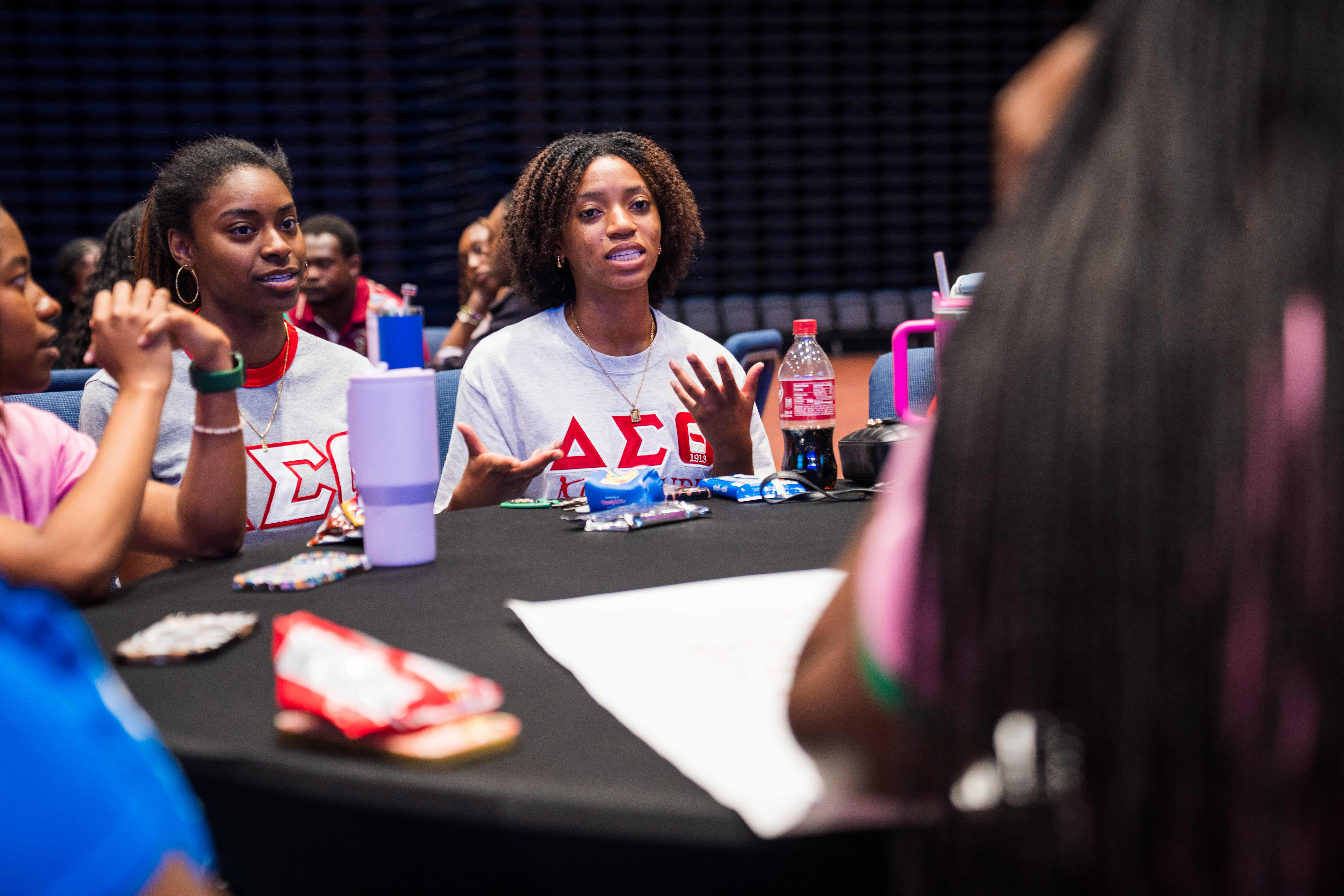 Two women discussing at a round table.