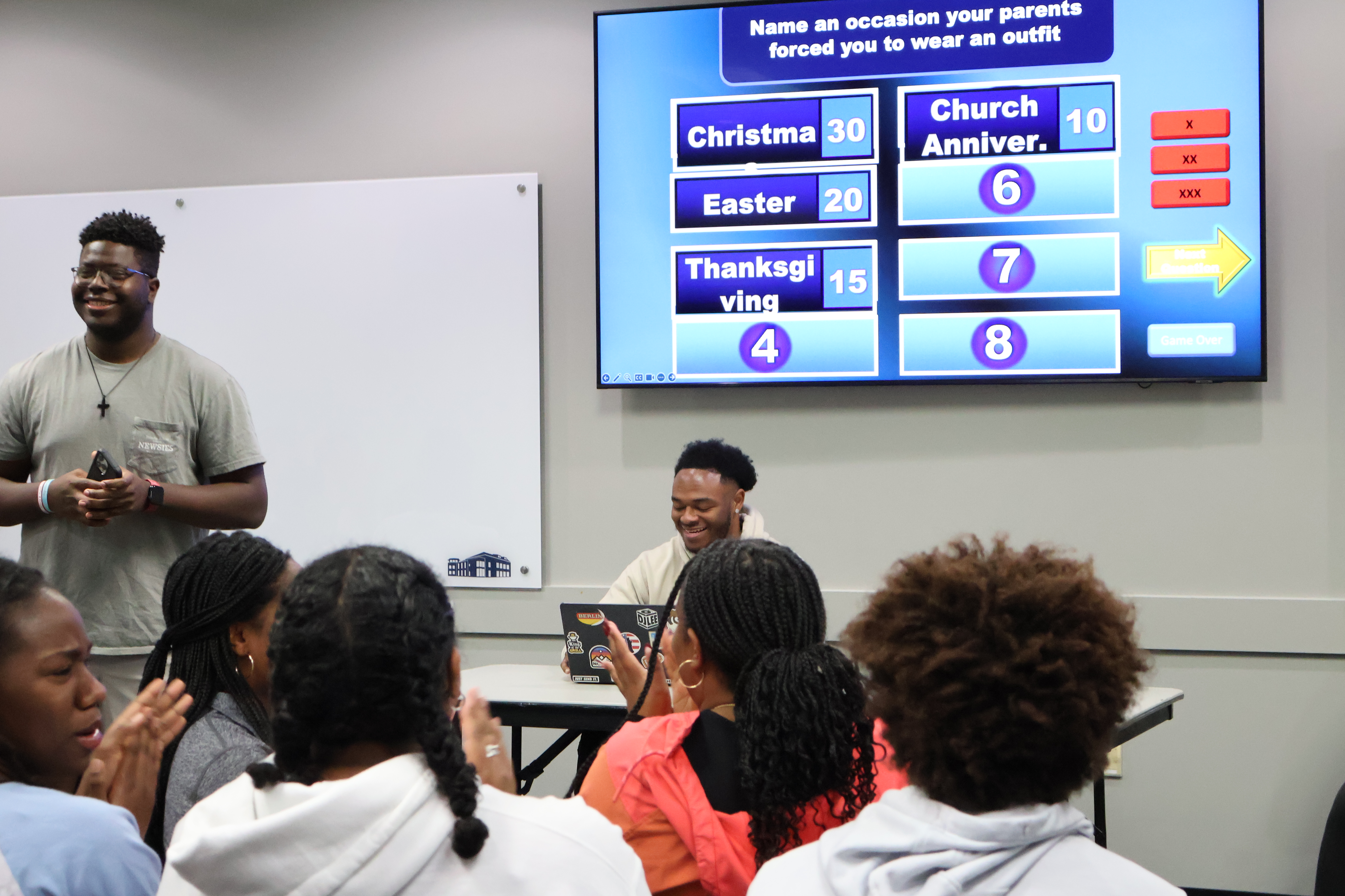 People playing a game with a man leading in front of the group.