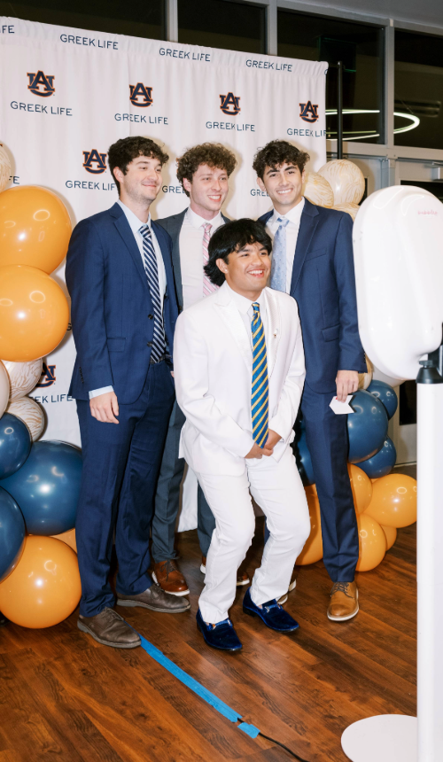Four men posing at a photobooth.