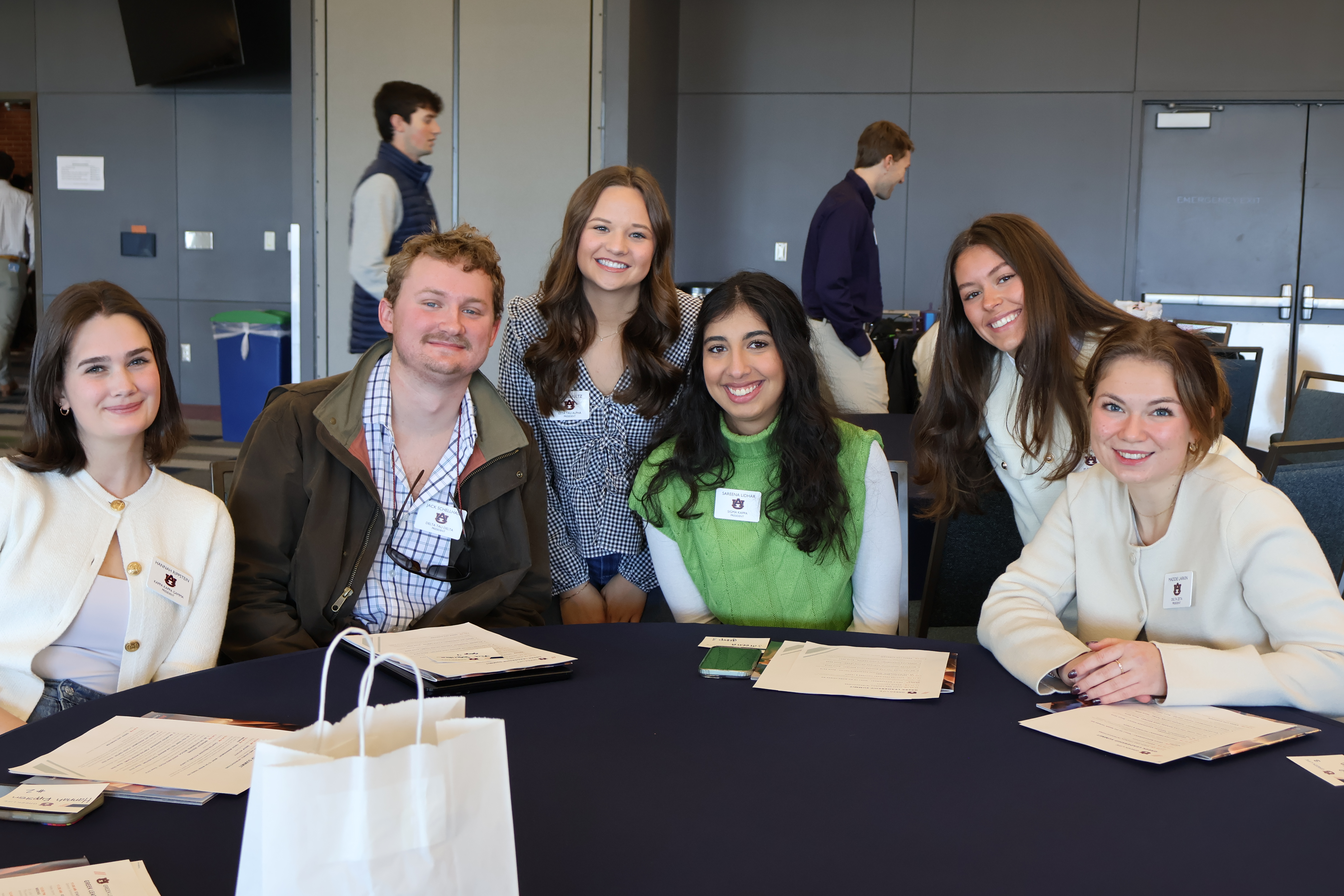 Group of people sitting and smiling.