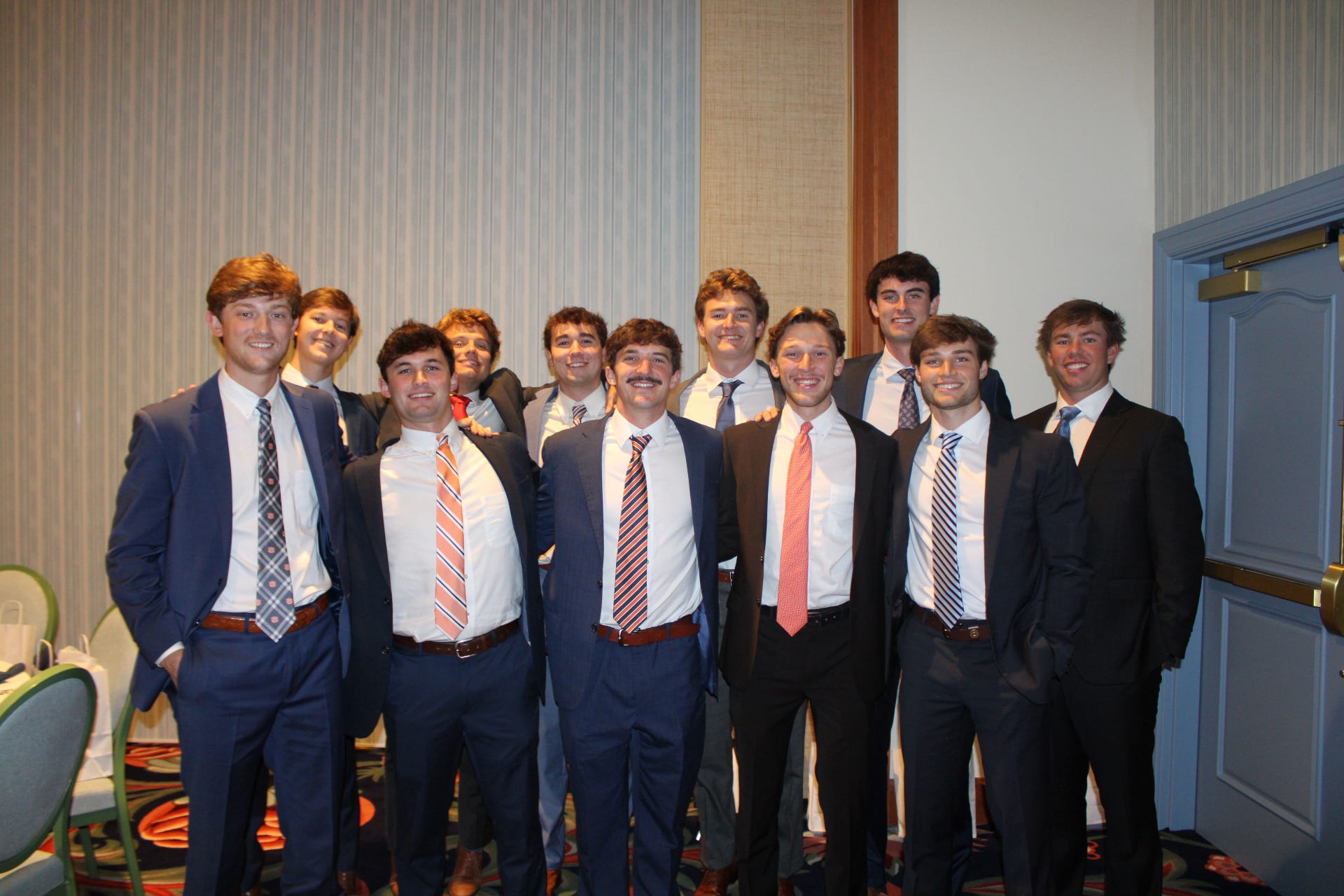 Men posing in a group in suits.