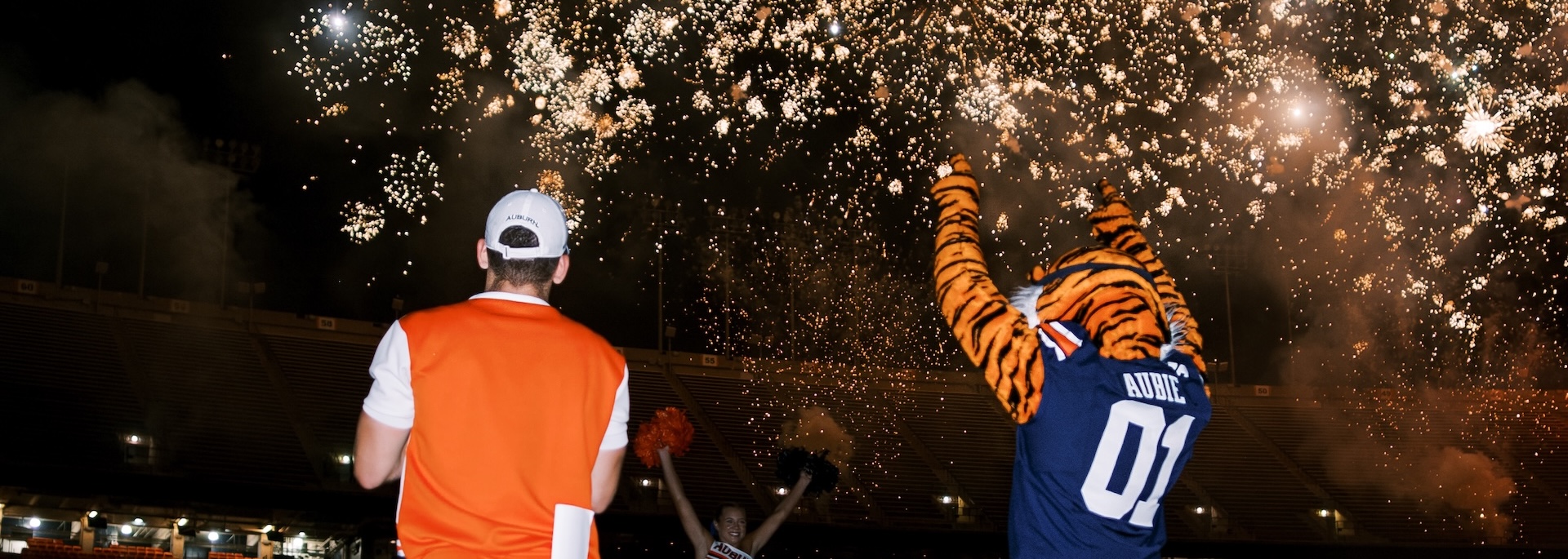 the mic man and aubie watch fireworks at convocation