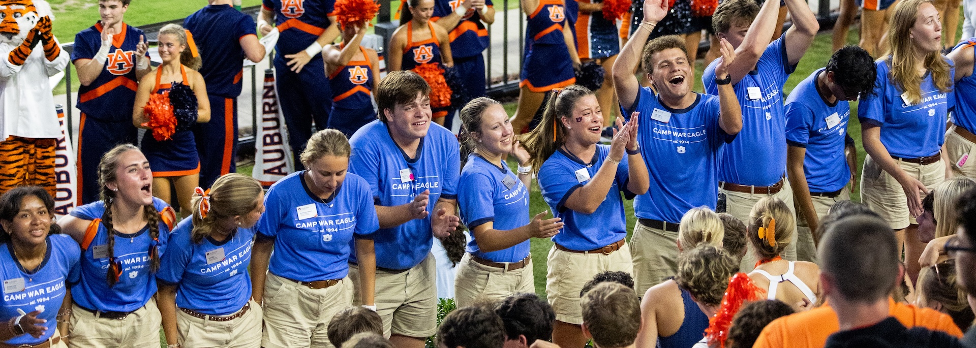 camp war eagle counselors leading students in a cheer in jordan-hare stadium