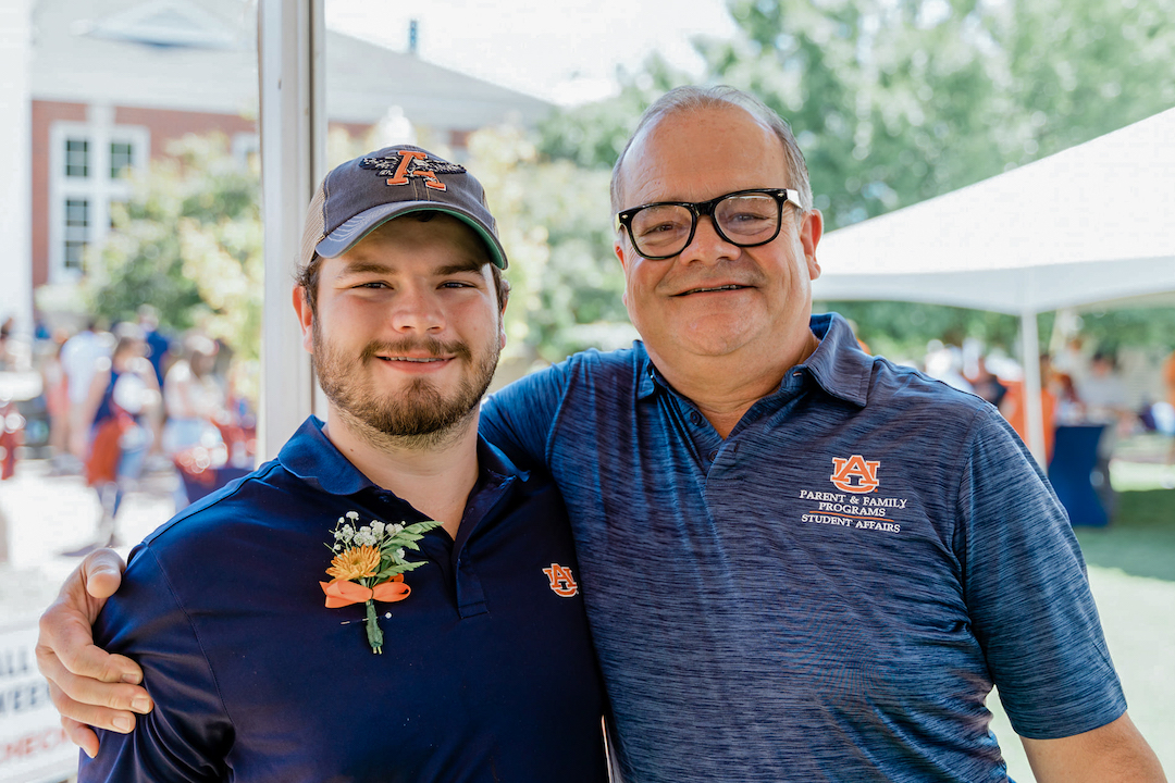 Father and son posing for a photo at an event